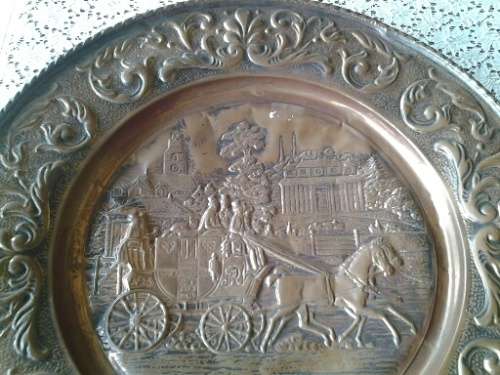 large copper display plate with a horse and carriage scene