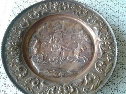 large copper display plate with a horse and carriage scene