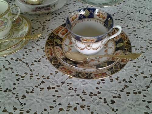 assorted lot of five vintage porcelain tea cup trios with gold tea spoons