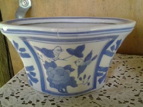 A pair of pretty blue and white floral and bird scene pot plant holders please note the listing