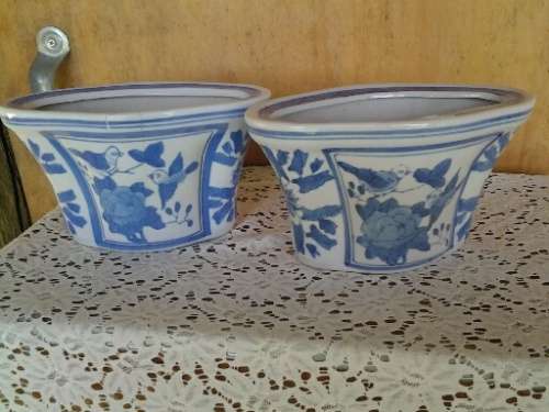 A pair of pretty blue and white floral and bird scene pot plant holders please note the listing