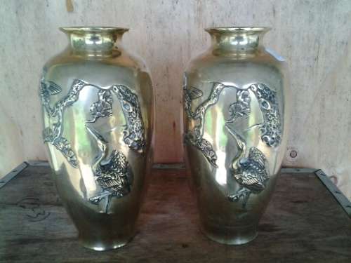 A pair of bird scene brass vases