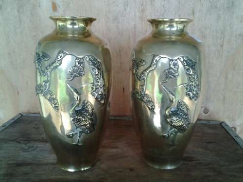 A pair of bird scene brass vases