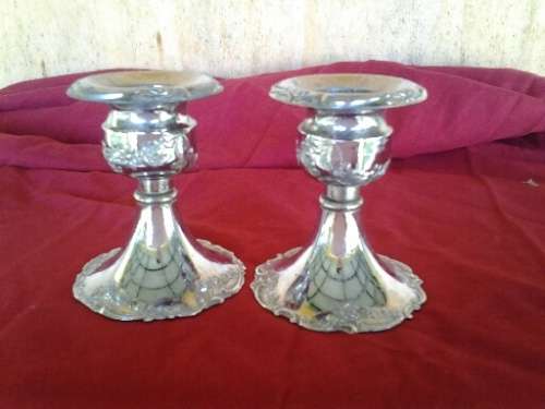 A pair of small pretty sliver plated chrome candle stick holders
