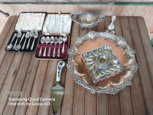 A lot of vintage sliver plated tea spoons ..tray ..tea strainer etc
