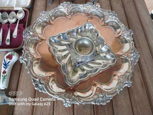A lot of vintage sliver plated tea spoons ..tray ..tea strainer etc