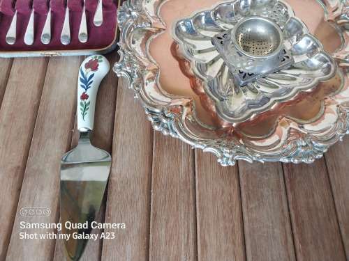 A lot of vintage sliver plated tea spoons ..tray ..tea strainer etc