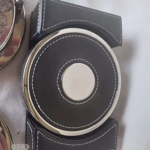 Three assorted  coasters  two sliver plated one leather