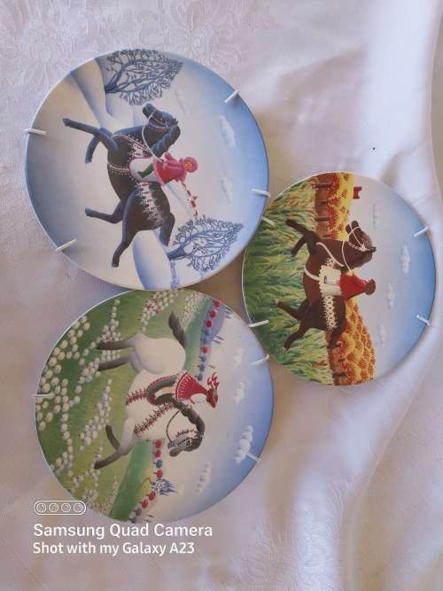 A set of three Poole small horse scene display plates
