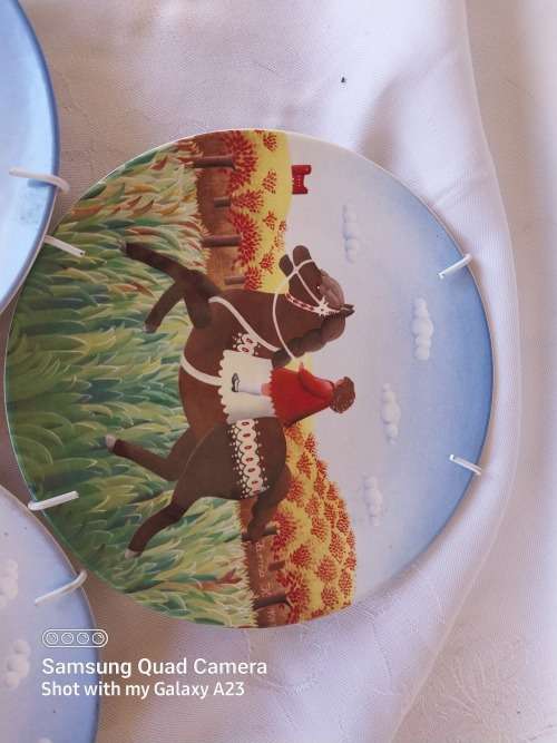 A set of three Poole small horse scene display plates