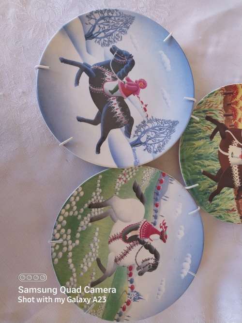 A set of three Poole small horse scene display plates
