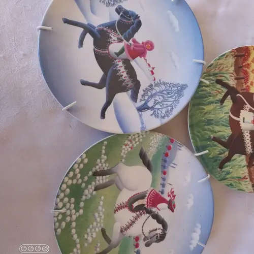 A set of three Poole small horse scene display plates