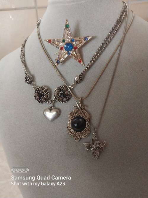 Three assorted necklaces and a star brooch