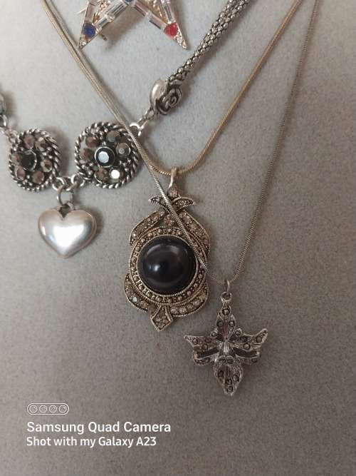 Three assorted necklaces and a star brooch
