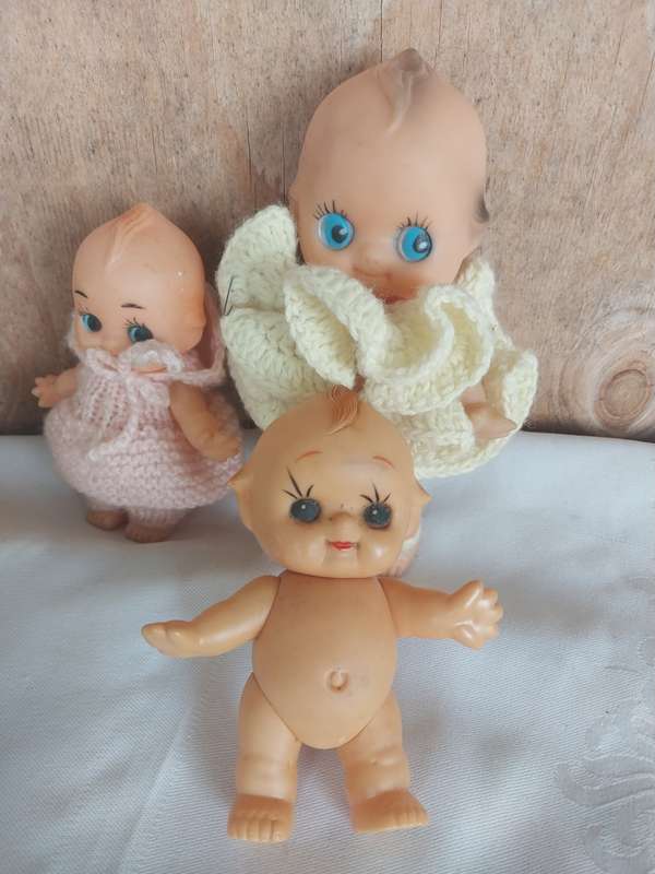 Three assorted kewpie dolls