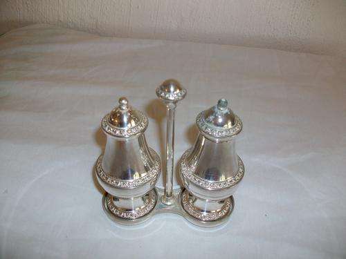 sliver plated set of salt and pepper with a stand
