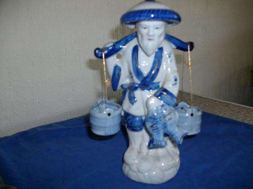 chinese man ornaments holding buckets and fish