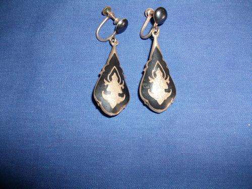 A sliver plated screw on earrings detailed