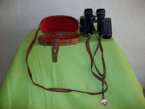 A binoculars with leather strap and in the original leather case
