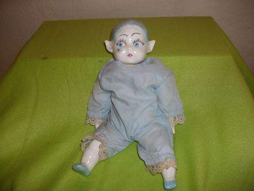 A blue pixie porcelain doll  .
