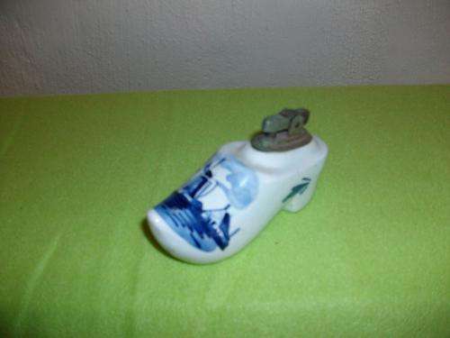 A ceramic delft shoe with lighter