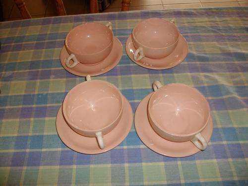 set of four plain pink cups and saucers