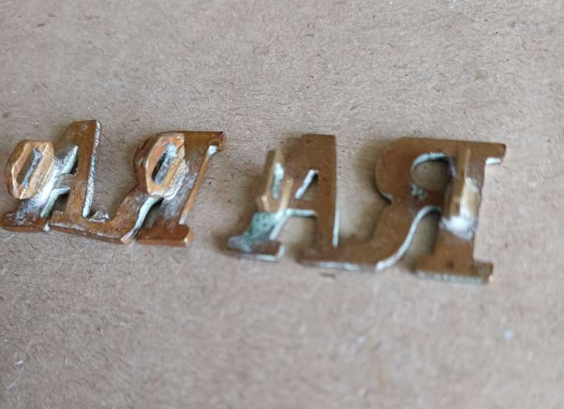 Royal Artillery brass titles with WWI D type lugs