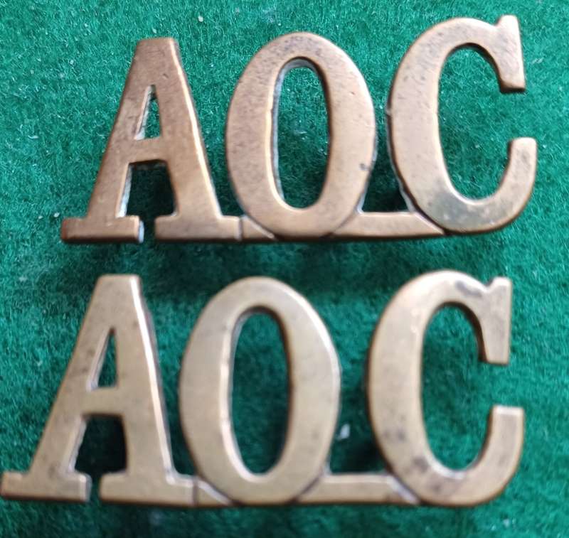 British Army Ordnance Corps brass titles pair, D lugs
