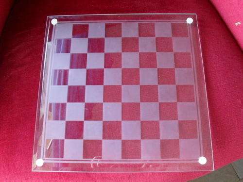A MARKED OUT GLASS GAME BOARD -chess, draughts......