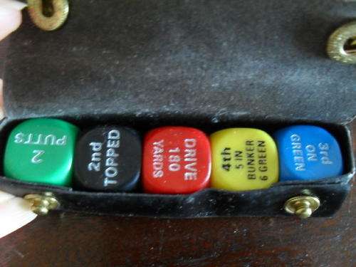 A PACK OF GOLF DICE IN A CASE.