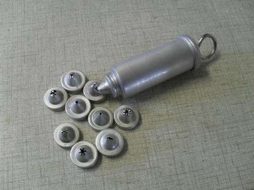 A VINTAGE ALUMINIUM CAKE ICING TUBE including 10 ICING NOZZLES