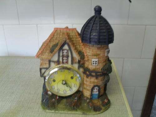 A FUN CASTLE CLOCK -resin?  CLOCK WORKING -25cm tall base 18cm x 13cm. CLOCK FACE 8.5cm across