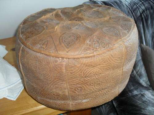 a VINTAGE PRESSED LEATHER MORROCAN  POUFF - with a camel motif