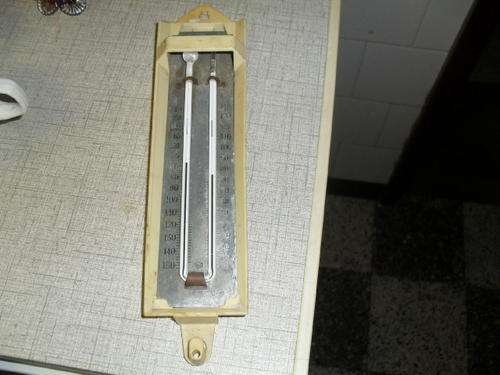 (35)A WALL MOUNTED TEMPERATURE GAUGE -made by B.H ZEAL, LONDON, ENGLAND -28cm long -plastic casing