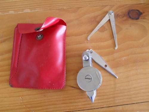 A VINTAGE BUILDERS PLUMB WEIGHT in its original sleeve.