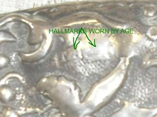 A silver marked repousse hair brush
