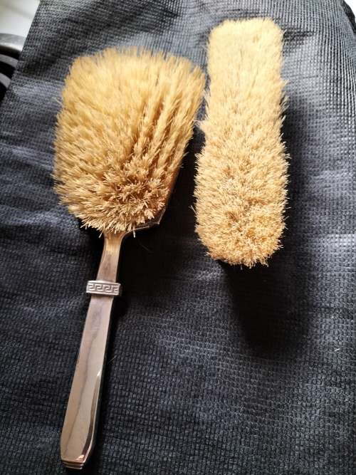 A VINTAGE BIRMINGHAM SILVER HAIRBRUSH AND CLOTHES BRUSH