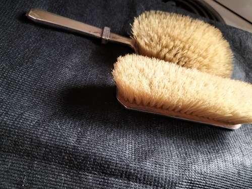 A VINTAGE BIRMINGHAM SILVER HAIRBRUSH AND CLOTHES BRUSH