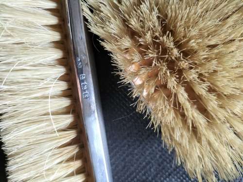 A VINTAGE BIRMINGHAM SILVER HAIRBRUSH AND CLOTHES BRUSH