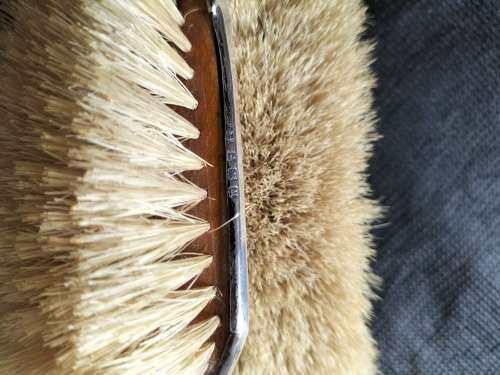 A VINTAGE BIRMINGHAM SILVER HAIRBRUSH AND CLOTHES BRUSH