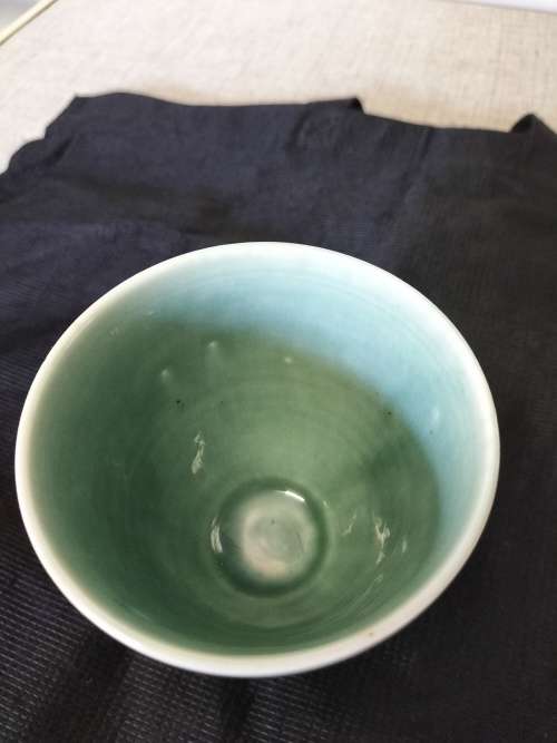 A CERAMIC JADE COLOURED CALEDON LIKE, GOBLET.- NO MARKINGS.