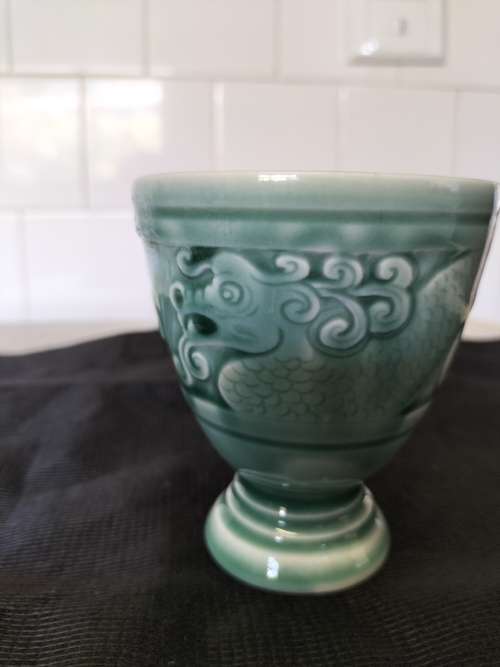 A CERAMIC JADE COLOURED CALEDON LIKE, GOBLET.- NO MARKINGS.