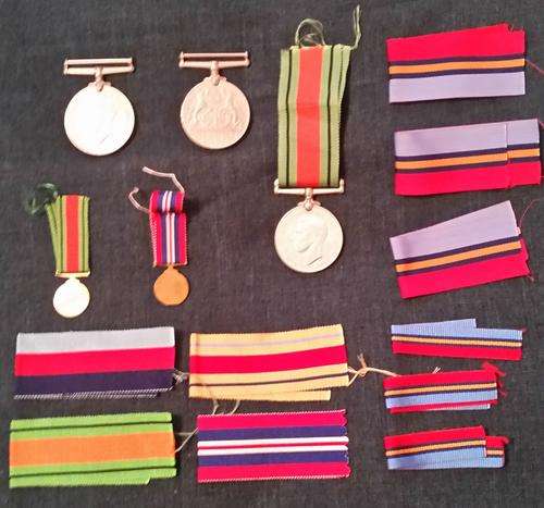 Medals and extra ribbons, the miniatures are blanks  not issued scarce.