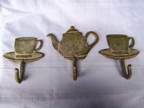 CAST IRON HOOKS. TEA CUPS AND POT