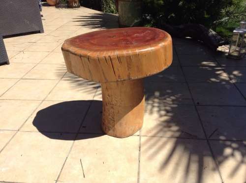 A mushroom shaped tree stump side table or foot stool