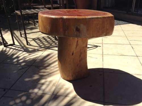 A mushroom shaped tree stump side table or foot stool