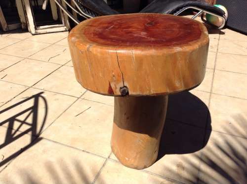 A mushroom shaped tree stump side table or foot stool