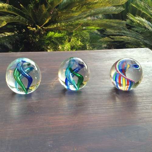 3x glass ball paperweight