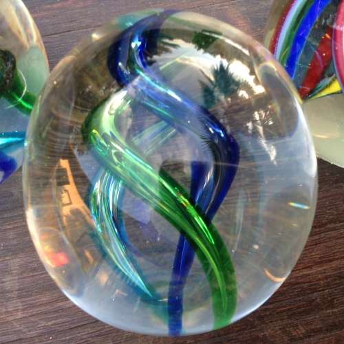 3x glass ball paperweight