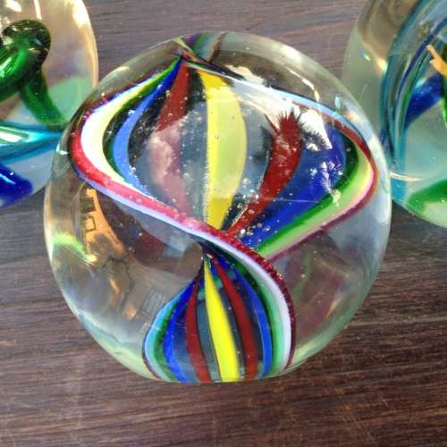 3x glass ball paperweight